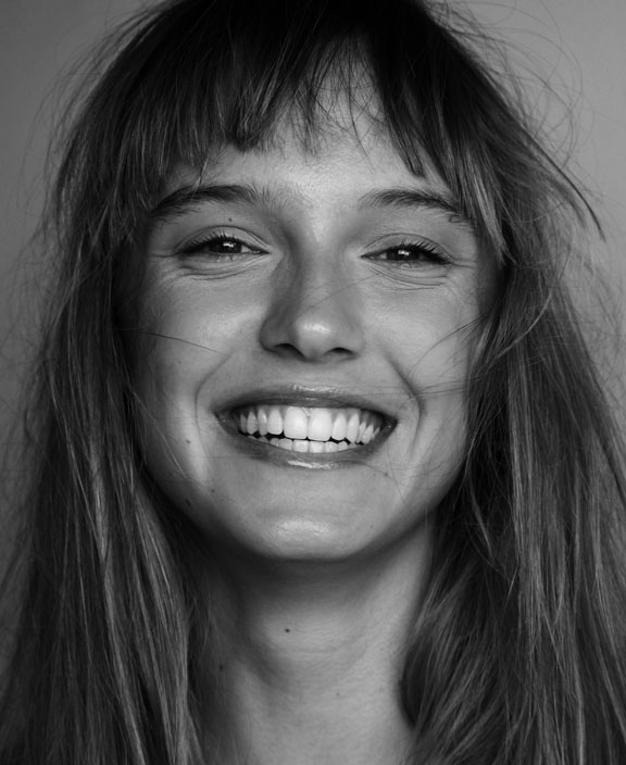 black and white photo of young woman smiling